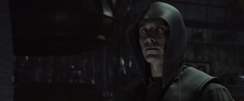 Movie still from “Alien: Covenant” (2017), directed by Ridley Scott – A man in a hooded jacket looking at the camera; Close Up shot, Low angle