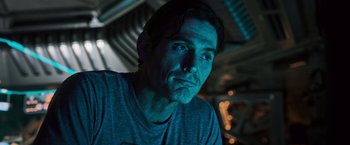 Movie still from “Alien: Covenant” (2017), directed by Ridley Scott – A person wearing a gray t - shirt; Close Up shot, Low angle