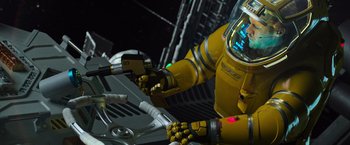 Movie still from “Alien: Covenant” (2017), directed by Ridley Scott – A robot with a yellow suit and a yellow helmet on it; Medium shot, Overhead angle