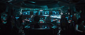 Movie still from “Alien: Covenant” (2017), directed by Ridley Scott – A man sitting at a desk in a room with many screens; Wide shot, High angle