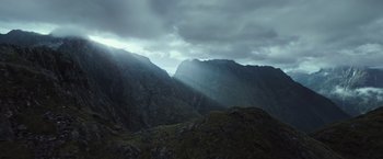 Movie still from “Alien: Covenant” (2017), directed by Ridley Scott – A view of a mountain range with a cloudy sky above it; Extreme Wide shot, Low angle