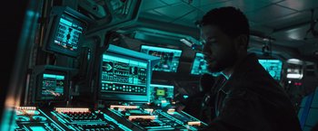 Movie still from “Alien: Covenant” (2017), directed by Ridley Scott – A man sitting in front of a computer monitor; Medium shot, High angle