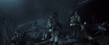 Movie still from “Alien: Covenant” (2017), directed by Ridley Scott – A group of people in the dark with backpacks; Wide shot, Low angle