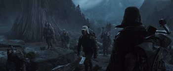 Movie still from “Alien: Covenant” (2017), directed by Ridley Scott – A group of people walking through a rocky area; Medium shot, Low angle