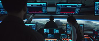 Movie still from “Alien: Covenant” (2017), directed by Ridley Scott – A group of people sitting in front of a large window; Wide shot, Over the shoulder angle