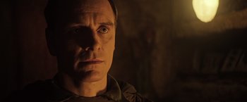 Movie still from “Alien: Covenant” (2017), directed by Ridley Scott – A man's face in the dark; Close Up shot, Low angle