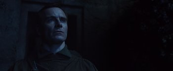 Movie still from “Alien: Covenant” (2017), directed by Ridley Scott – A man standing in the dark looking up at the sky; Close Up shot, Low angle