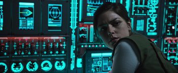 Movie still from “Alien: Covenant” (2017), directed by Ridley Scott – A woman standing in front of a wall of electronic equipment; Close Up shot, Low angle