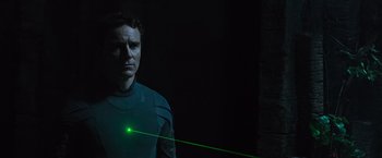 Movie still from “Alien: Covenant” (2017), directed by Ridley Scott – A man in a black shirt and a green laser beam; Medium shot, Low angle