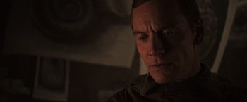 Movie still from “Alien: Covenant” (2017), directed by Ridley Scott – A man's face in the dark; Close Up shot, Over the shoulder angle