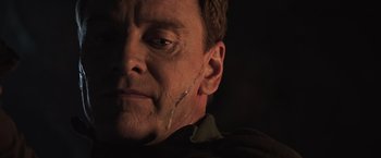 Movie still from “Alien: Covenant” (2017), directed by Ridley Scott – A man's face in the dark; Close Up shot, Over the shoulder angle