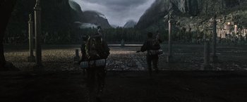 Movie still from “Alien: Covenant” (2017), directed by Ridley Scott – A group of people walking across a dirt road; Extreme Wide shot, High angle