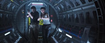 Movie still from “Alien: Covenant” (2017), directed by Ridley Scott – A man and a woman standing inside of a building; Medium shot, Low angle