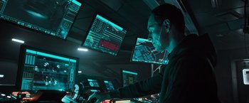 Movie still from “Alien: Covenant” (2017), directed by Ridley Scott – A man is looking at multiple computer screens; Medium shot, Over the shoulder angle