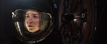 Movie still from “Alien: Covenant” (2017), directed by Ridley Scott – A woman is reflected in the mirror of an astronaut helmet; Close Up shot, Low angle