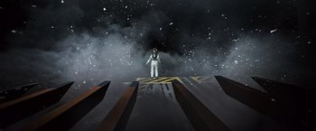 Movie still from “Alien: Covenant” (2017), directed by Ridley Scott – An astronaut standing on top of a building in the dark; Extreme Wide shot, Overhead angle