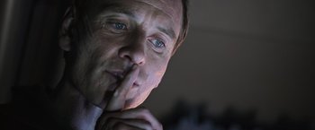 Movie still from “Alien: Covenant” (2017), directed by Ridley Scott – A person holding his finger to his lips; Close Up shot, Over the shoulder angle