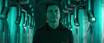 Movie still from “Alien: Covenant” (2017), directed by Ridley Scott – A man standing in a room with green lighting; Close Up shot, Low angle