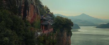A house on a cliff overlooking a body of water