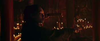 A man holding a knife up to his head