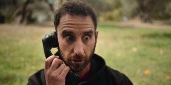 Movie still from “All About Gila” (2022), directed by Arturo González-Campos – A person talking on a phone; Close Up shot, Low angle