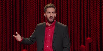 Movie still from “All About Gila” (2022), directed by Arturo González-Campos – A man in a red shirt and a black jacket; Medium shot, High angle