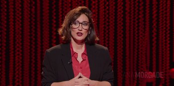 Movie still from “All About Gila” (2022), directed by Arturo González-Campos – A woman in a red shirt and black jacket; Close Up shot, High angle