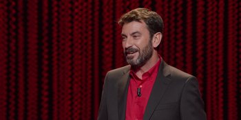 Movie still from “All About Gila” (2022), directed by Arturo González-Campos – A man in a red shirt and black jacket; Medium shot, High angle