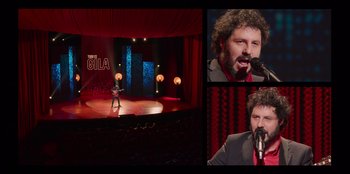 Movie still from “All About Gila” (2022), directed by Arturo González-Campos – A collage of a man performing on stage; Wide shot, Over the shoulder angle