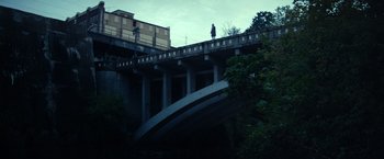 Movie still from “All the Bright Places” (2020), directed by Brett Haley – A person standing on a bridge over a river; Extreme Wide shot, Low angle