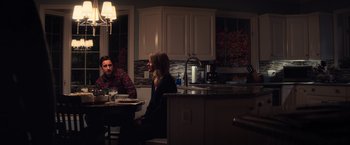 Movie still from “All the Bright Places” (2020), directed by Brett Haley – A man and a woman sitting at a table in a kitchen; Medium shot, Over the shoulder angle