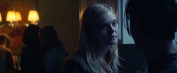 Movie still from “All the Bright Places” (2020), directed by Brett Haley – A young blonde haired woman sitting in front of a window; Close Up shot, Over the shoulder angle