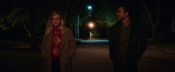 Movie still from “All the Bright Places” (2020), directed by Brett Haley – A man and a woman standing next to each other on a street; Medium shot, Low angle