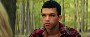 Movie still from “All the Bright Places” (2020), directed by Brett Haley – A young man with a plaid shirt is looking at the camera; Close Up shot, High angle
