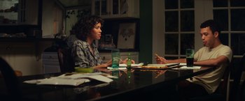 Movie still from “All the Bright Places” (2020), directed by Brett Haley – Two people are sitting at a table in a kitchen; Medium shot, Over the shoulder angle