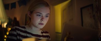 Movie still from “All the Bright Places” (2020), directed by Brett Haley – A young girl is looking at a computer screen; Close Up shot, Low angle