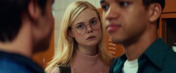 Movie still from “All the Bright Places” (2020), directed by Brett Haley – A young woman wearing glasses looking at the camera; Close Up shot, Over the shoulder angle