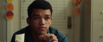 Movie still from “All the Bright Places” (2020), directed by Brett Haley – A young man is sitting in front of a window; Close Up shot, Over the shoulder angle