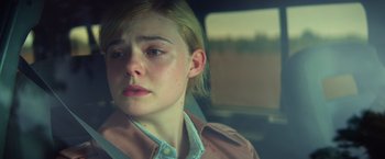 Movie still from “All the Bright Places” (2020), directed by Brett Haley – A young woman sitting in a car looking sad; Close Up shot, Over the shoulder angle