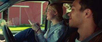 Movie still from “All the Bright Places” (2020), directed by Brett Haley – A woman sitting in the back seat of a car; Medium shot, Over the shoulder angle