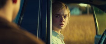 Movie still from “All the Bright Places” (2020), directed by Brett Haley – A woman looking out of a car window at the camera; Close Up shot, Over the shoulder angle