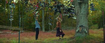 Movie still from “All the Bright Places” (2020), directed by Brett Haley – Two people in a field throwing shoes into the air; Extreme Wide shot, Low angle