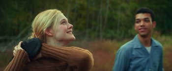 Movie still from “All the Bright Places” (2020), directed by Brett Haley – A young blonde haired woman wearing a brown coat; Close Up shot, Over the shoulder angle