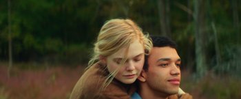 Movie still from “All the Bright Places” (2020), directed by Brett Haley – A young woman is being carried by a man; Close Up shot, Over the shoulder angle