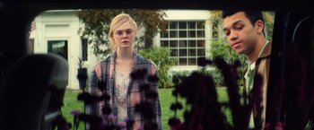 Movie still from “All the Bright Places” (2020), directed by Brett Haley – A woman standing in front of a building; Medium shot, Over the shoulder angle