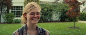 Movie still from “All the Bright Places” (2020), directed by Brett Haley – A woman with glasses smiling for the camera; Close Up shot, Over the shoulder angle