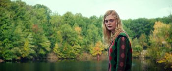 Movie still from “All the Bright Places” (2020), directed by Brett Haley – A young blonde woman standing next to a body of water; Medium shot, Low angle