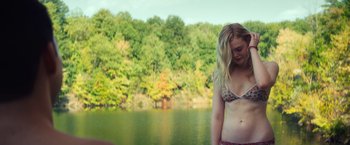 Movie still from “All the Bright Places” (2020), directed by Brett Haley – A woman in a bikini standing next to a body of water; Medium shot, Over the shoulder angle