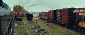 Movie still from “All the Bright Places” (2020), directed by Brett Haley – Two people on a train track near a train yard; Extreme Wide shot, High angle