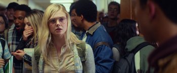 Movie still from “All the Bright Places” (2020), directed by Brett Haley – A woman with glasses standing next to a crowd of people; Close Up shot, Over the shoulder angle